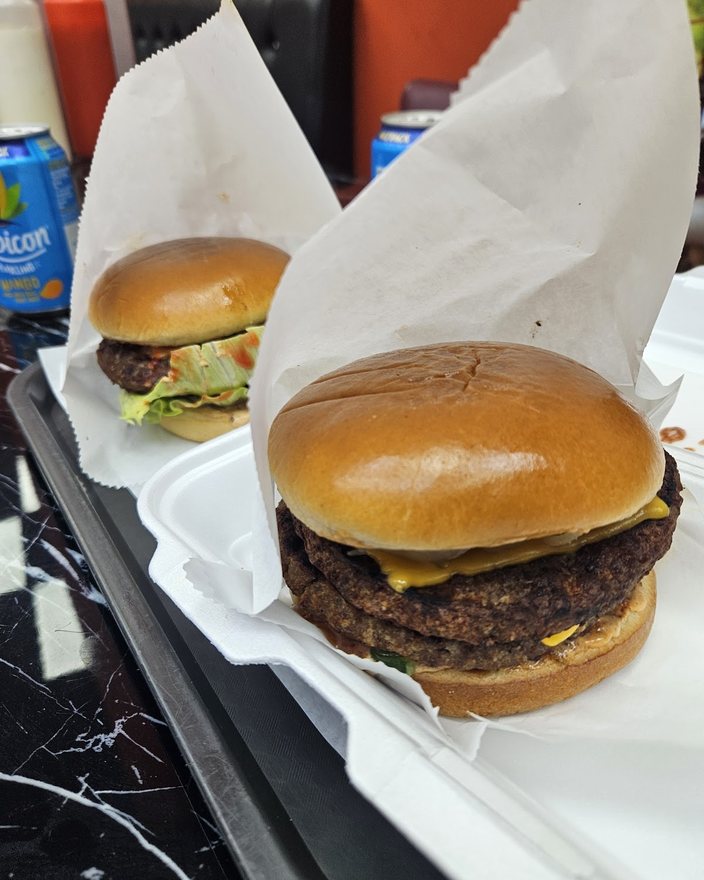Two cheeseburgers in a takeaway box